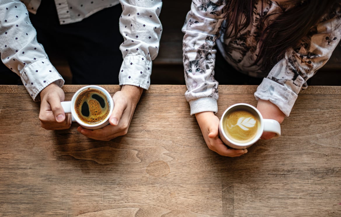 2 people drinking coffee together